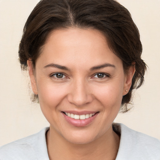 Joyful white young-adult female with medium  brown hair and brown eyes