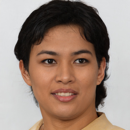 Joyful asian young-adult female with short  black hair and brown eyes