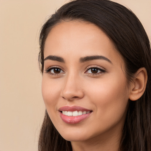 Joyful white young-adult female with long  brown hair and brown eyes