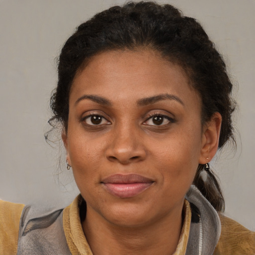 Joyful black young-adult female with short  brown hair and brown eyes