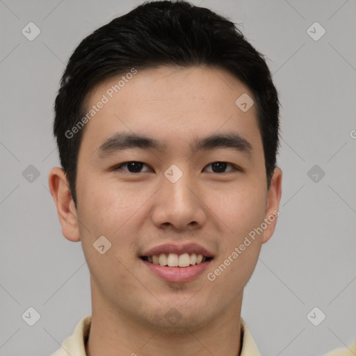 Joyful asian young-adult male with short  black hair and brown eyes