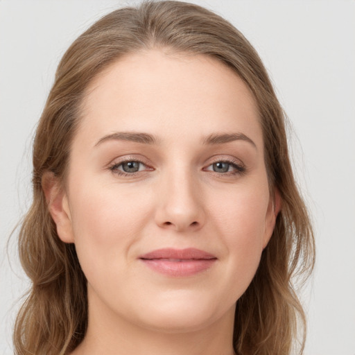 Joyful white young-adult female with long  brown hair and grey eyes