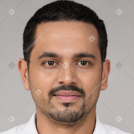 Joyful latino young-adult male with short  black hair and brown eyes