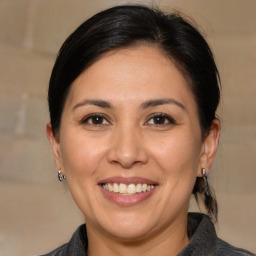 Joyful white adult female with medium  brown hair and brown eyes