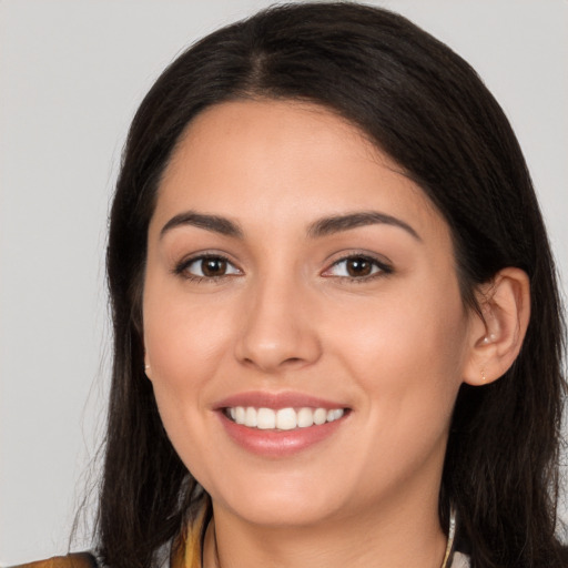 Joyful white young-adult female with long  brown hair and brown eyes