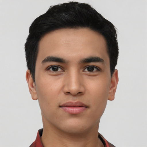 Joyful latino young-adult male with short  black hair and brown eyes