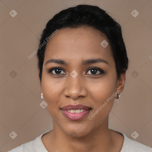 Joyful black young-adult female with short  black hair and brown eyes