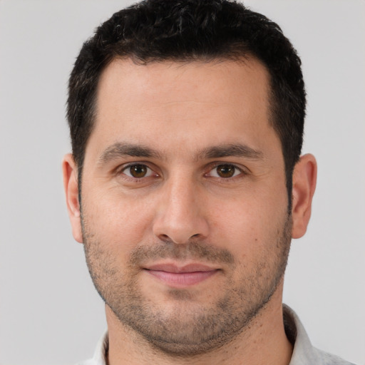 Joyful white young-adult male with short  brown hair and brown eyes