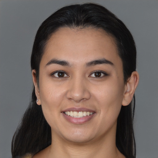 Joyful asian young-adult female with long  brown hair and brown eyes