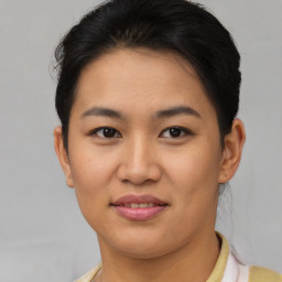 Joyful asian young-adult female with short  brown hair and brown eyes