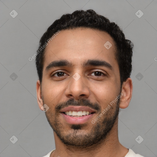 Joyful latino young-adult male with short  black hair and brown eyes