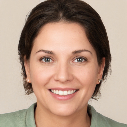 Joyful white young-adult female with medium  brown hair and brown eyes