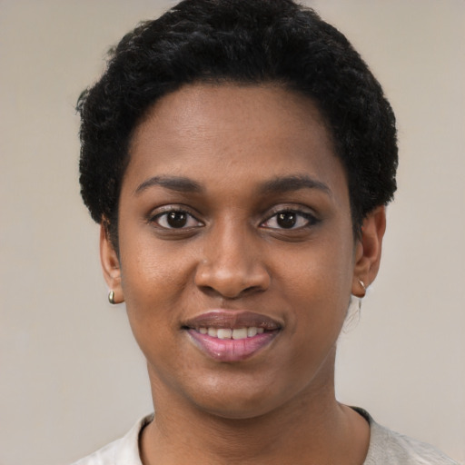 Joyful black young-adult female with short  black hair and brown eyes