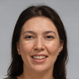 Joyful white adult female with medium  brown hair and brown eyes