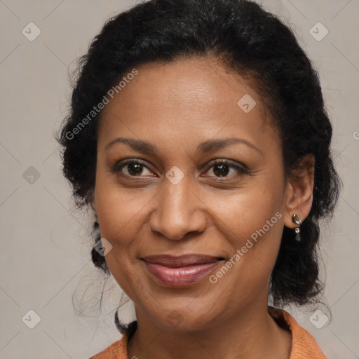 Joyful black adult female with medium  brown hair and brown eyes