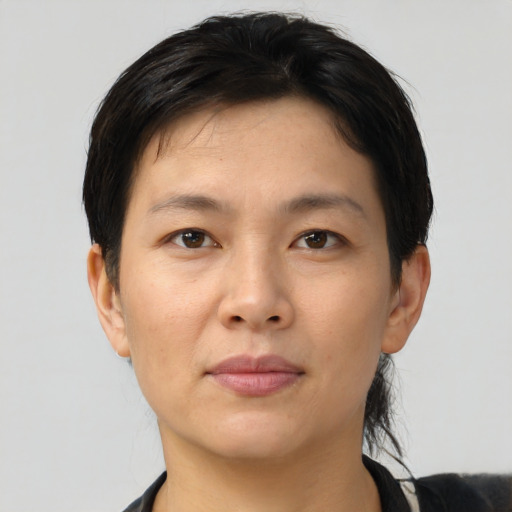 Joyful asian young-adult female with short  brown hair and brown eyes