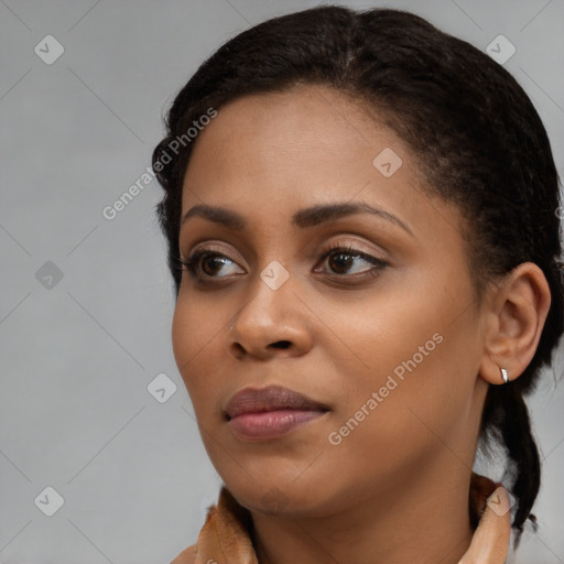 Joyful black young-adult female with medium  brown hair and brown eyes