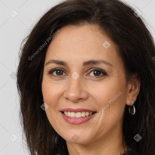 Joyful white adult female with long  brown hair and brown eyes