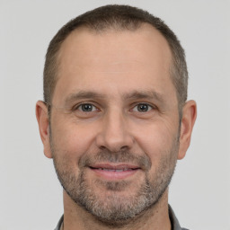 Joyful white adult male with short  brown hair and brown eyes