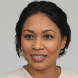 Joyful latino adult female with medium  brown hair and brown eyes