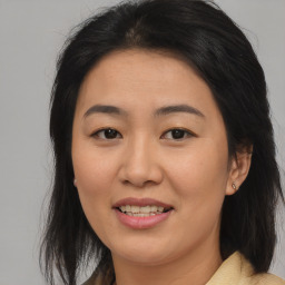 Joyful asian young-adult female with medium  brown hair and brown eyes