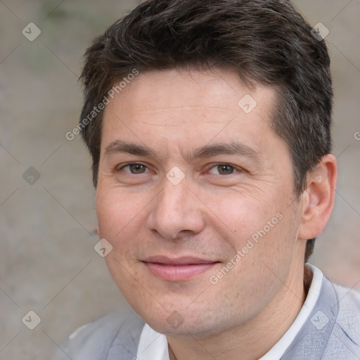 Joyful white adult male with short  brown hair and brown eyes