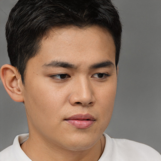 Joyful latino young-adult male with short  brown hair and brown eyes
