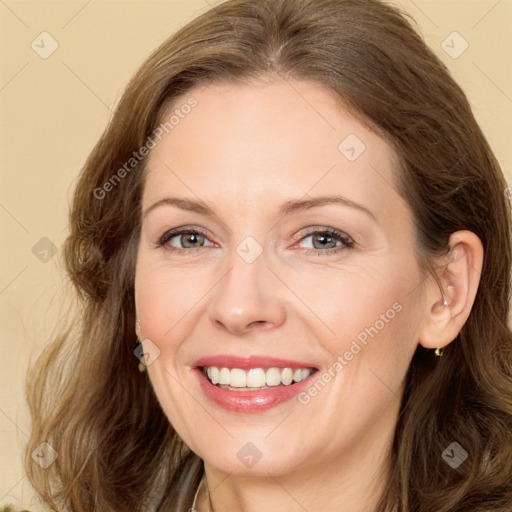 Joyful white adult female with long  brown hair and brown eyes