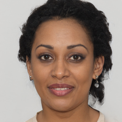 Joyful black adult female with short  brown hair and brown eyes