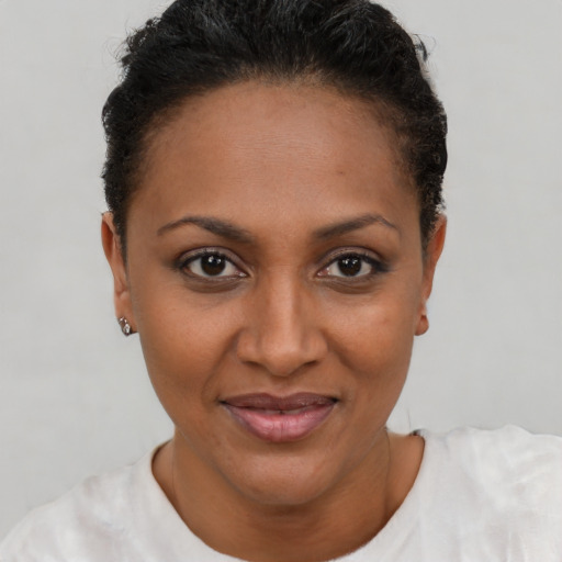 Joyful latino adult female with short  brown hair and brown eyes