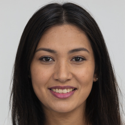 Joyful latino young-adult female with long  brown hair and brown eyes