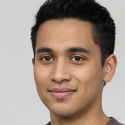 Joyful latino young-adult male with short  black hair and brown eyes