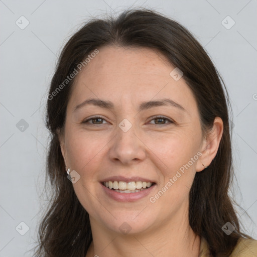 Joyful white adult female with long  brown hair and brown eyes