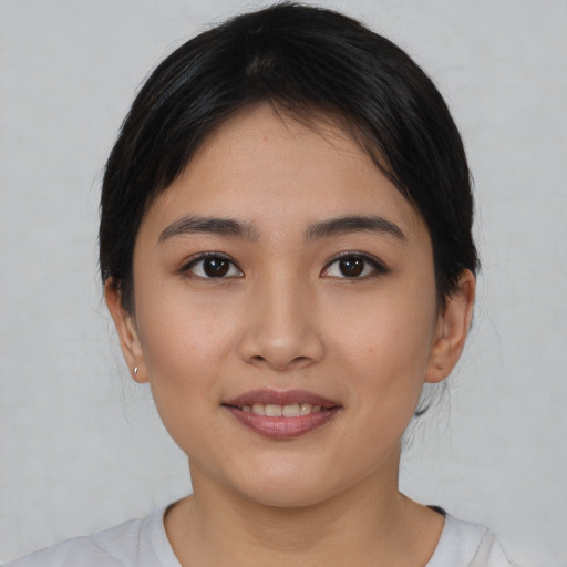 Joyful asian young-adult female with short  black hair and brown eyes