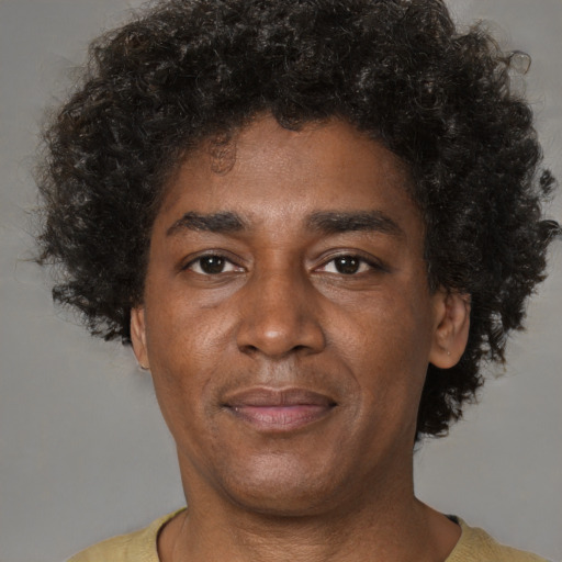 Joyful latino adult male with short  brown hair and brown eyes