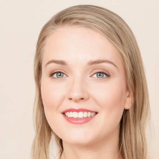 Joyful white young-adult female with long  brown hair and blue eyes