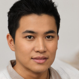 Joyful asian young-adult male with short  brown hair and brown eyes