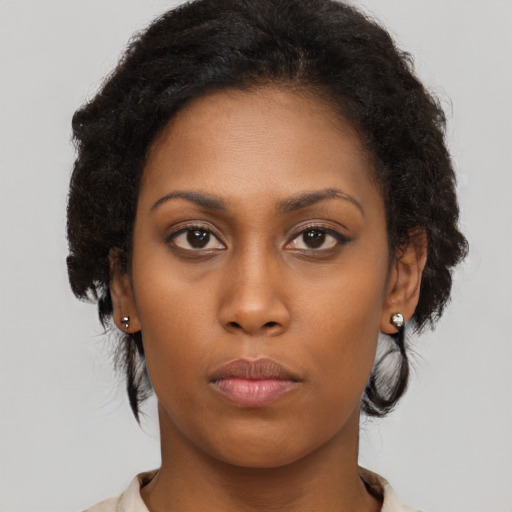 Neutral black young-adult female with long  brown hair and brown eyes