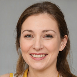 Joyful white young-adult female with medium  brown hair and brown eyes