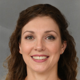 Joyful white young-adult female with long  brown hair and green eyes