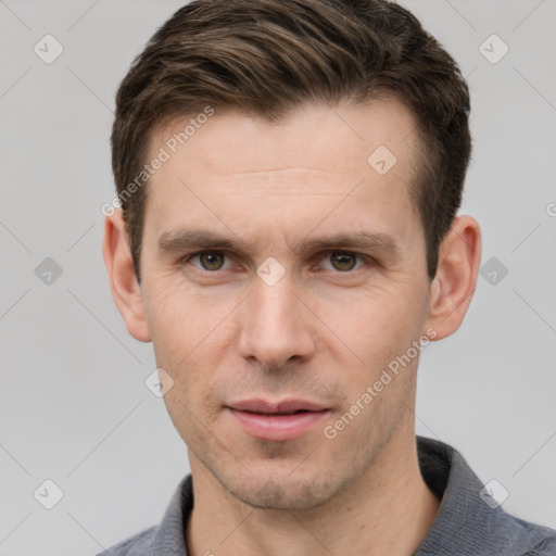 Joyful white adult male with short  brown hair and grey eyes