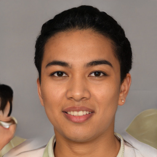 Joyful latino young-adult female with short  black hair and brown eyes
