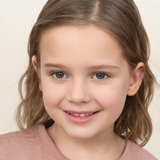 Joyful white child female with medium  brown hair and brown eyes