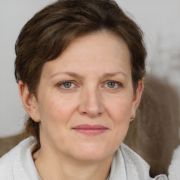 Joyful white adult female with medium  brown hair and grey eyes