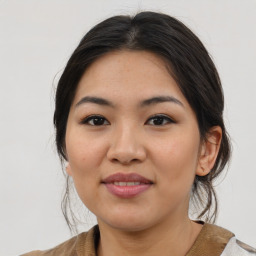 Joyful latino young-adult female with medium  brown hair and brown eyes