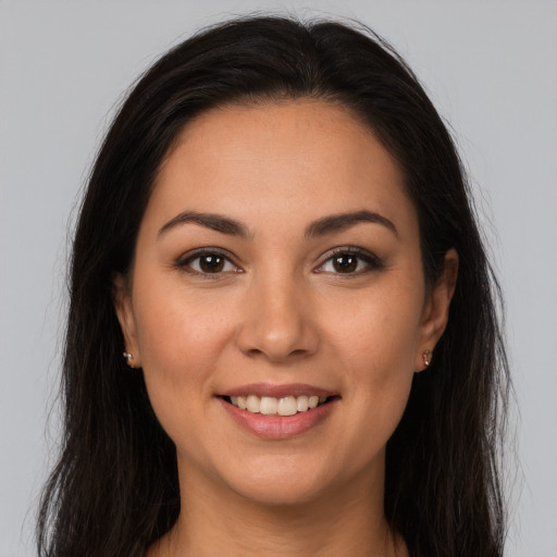 Joyful latino young-adult female with long  brown hair and brown eyes