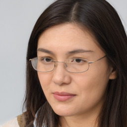 Joyful white adult female with long  brown hair and brown eyes