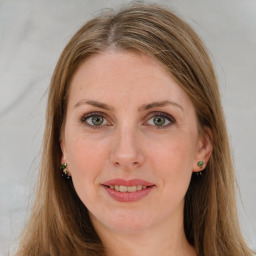 Joyful white young-adult female with long  brown hair and green eyes