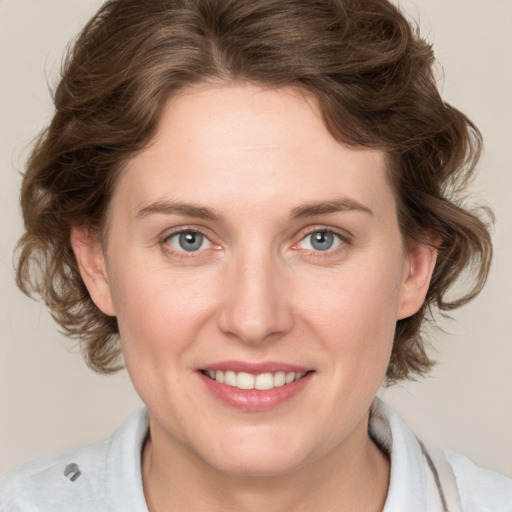 Joyful white young-adult female with medium  brown hair and blue eyes