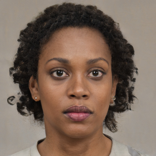 Neutral black young-adult female with medium  brown hair and brown eyes